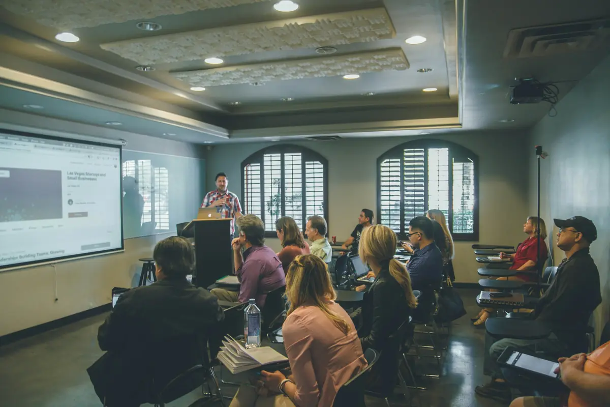 A large seminar room full of students listening to a presentation