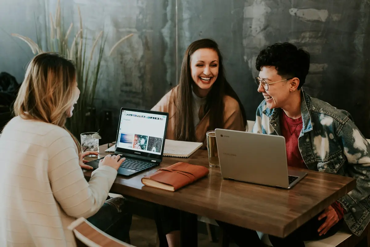 A small group of people working together around laptops